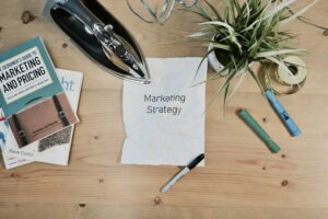 Papper med texten Marketing Strategy omgivet av böcker och kontorsmaterial som handlar om inbound strategy.